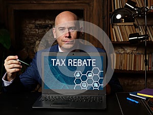 Business concept meaning TAX REBATE with phrase on the laptop. Tax rebateÂ refers to the relief you can claim to reduce incomeÂ 